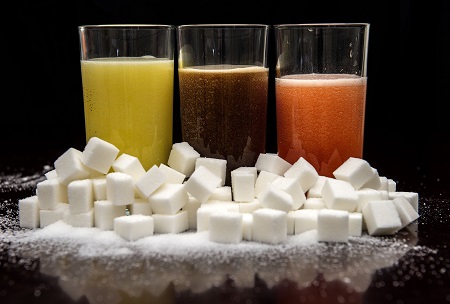 (carbonated drinks surrounded by sugar cubes as soft drink companies should set global sugar reduction targets to stop a worldwide obesity epidemic set to reach 1.12 billion people by 2030, a UK charity has urged Image/PA)