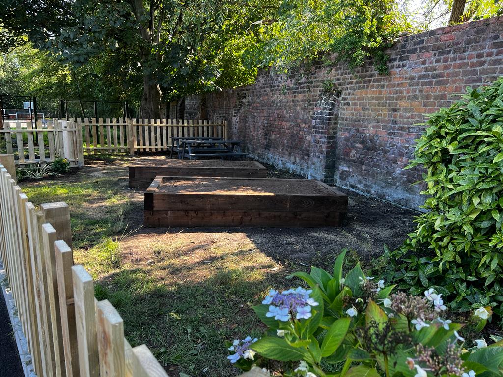 St Charles’ pupils and teachers with United Utilities, Morrison Water Services, B&Q and Travis Perkins, at the new school garden