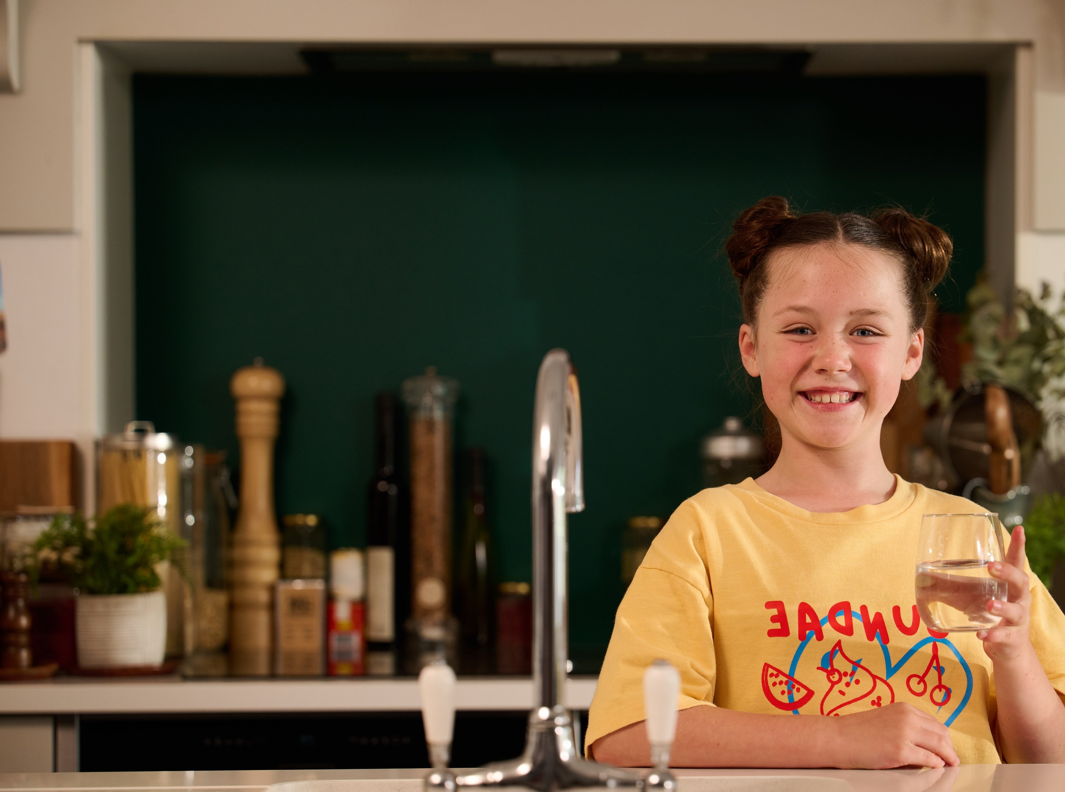 Girl holding glass of water